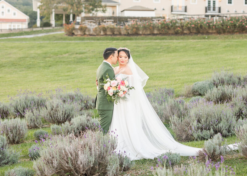 In the heart of Virginia's lavender paradise, a bride and groom embrace amidst the fragrant blooms. This photo encapsulates the essence of love in a picturesque setting photo by Vinluan Photography