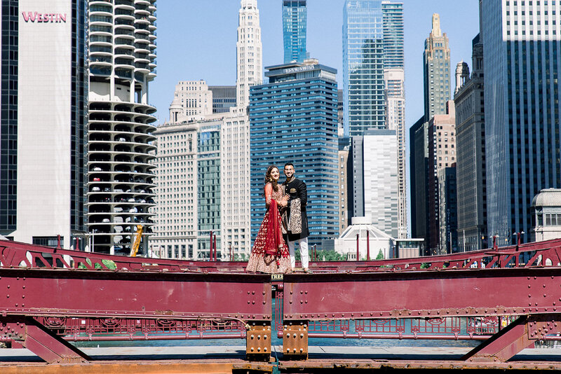 bride and groom standing on a chicago bridge