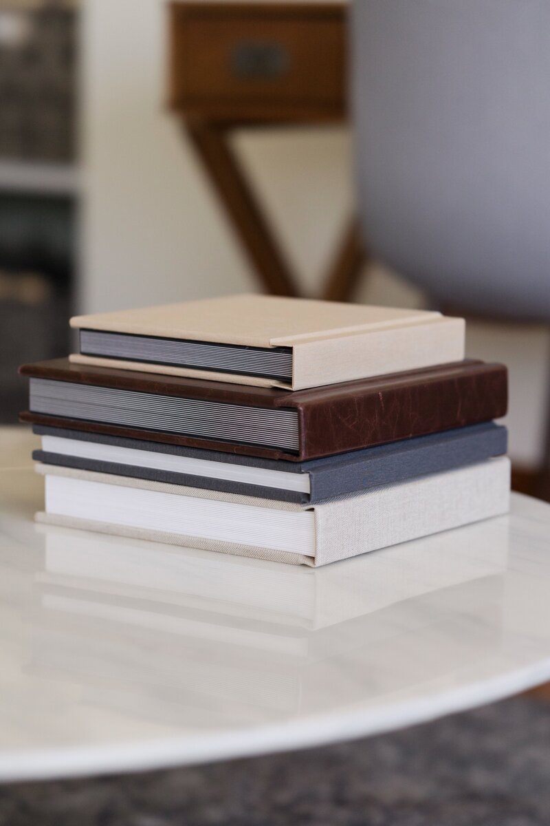 stack of leather photo albums displayed in living room