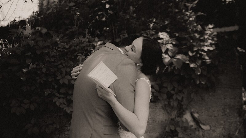 bride and groom at Hidden Meadow wedding Venue having their first look and reading their vows