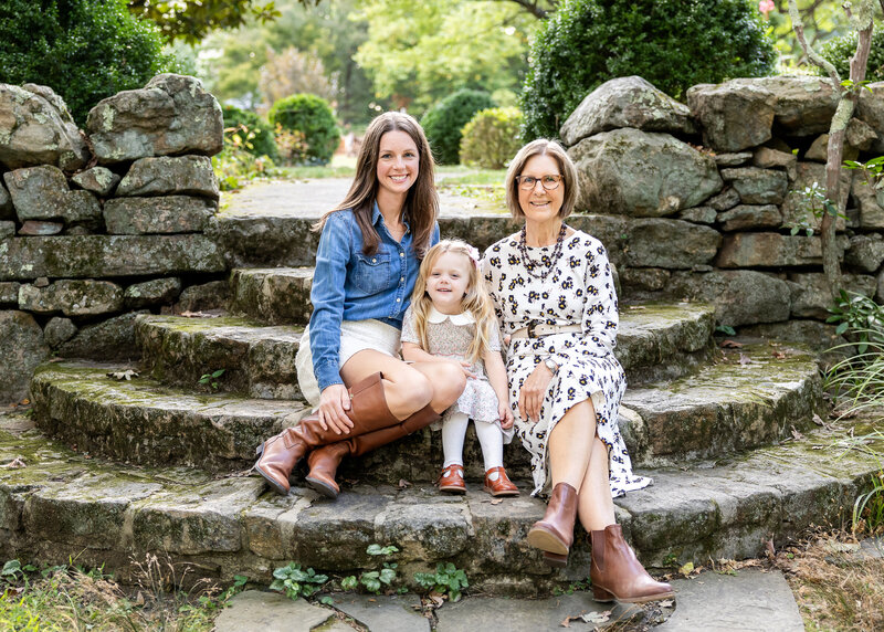 Grandparent, mother, and grandchild sitting in a NJ park.