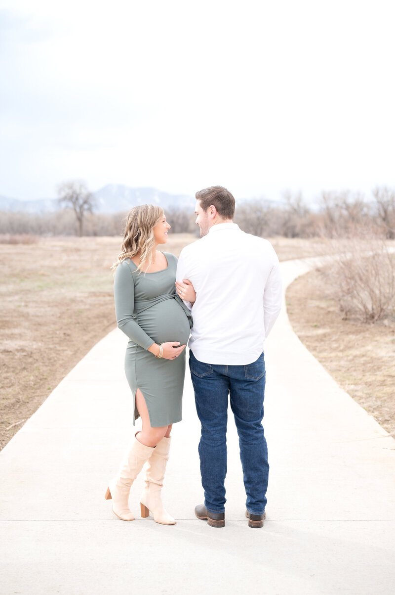 Wife holding her husband's arm while smiling together