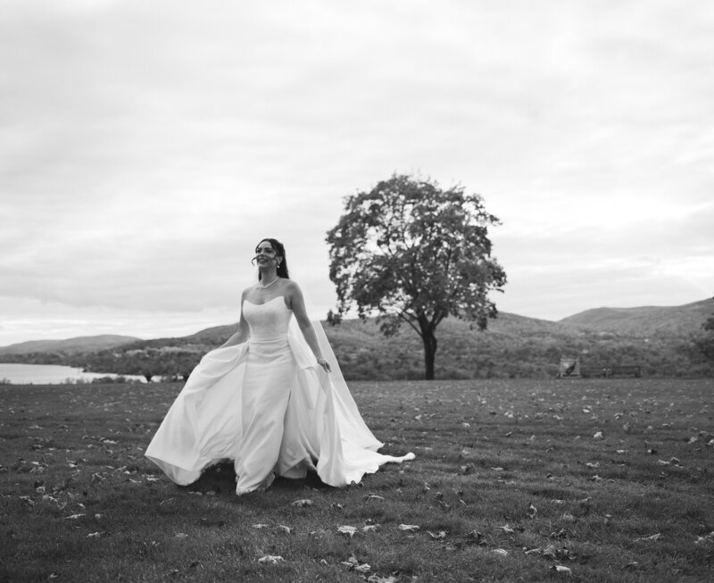Wedding portrait of bride running through field in the Hudson Valley at Boscobel House & Gardens