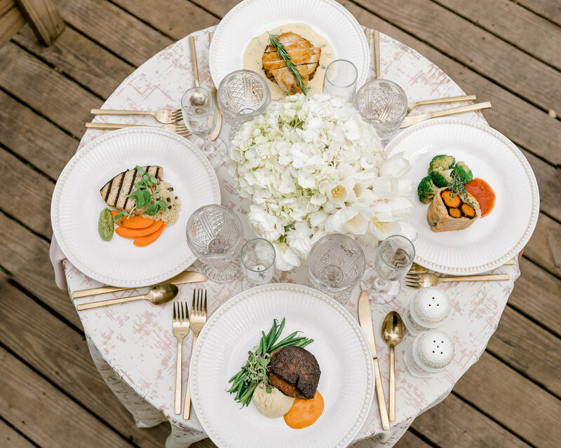 Close up photo of four plated dinners on a fancy table at Willowbrook Wedding venue