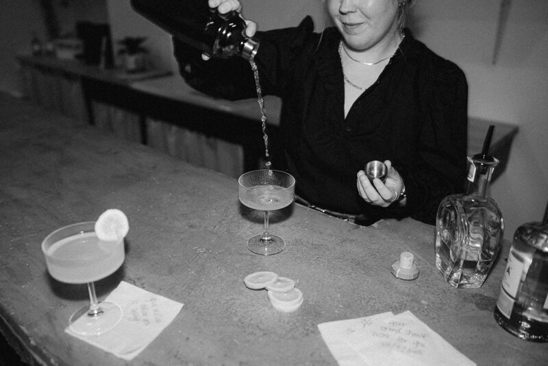 Lizzy Grant behind bar mixing drinks