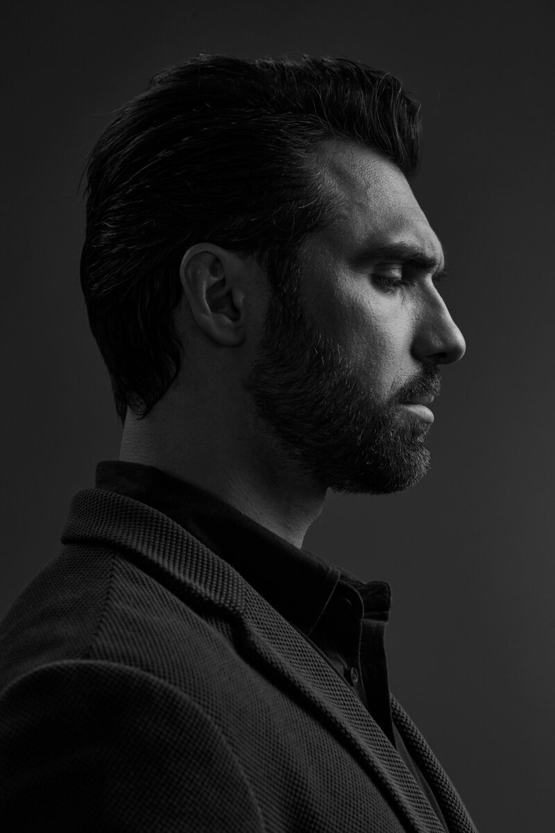 Moody portrait of Gamzat with a pensive expression, captured in profile by Ylva Erevall.
