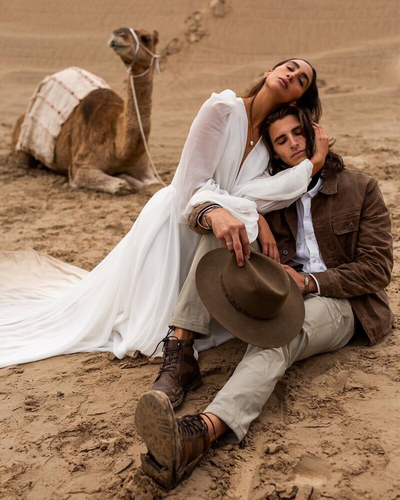 man holding woman in his arms at vail engagement photos