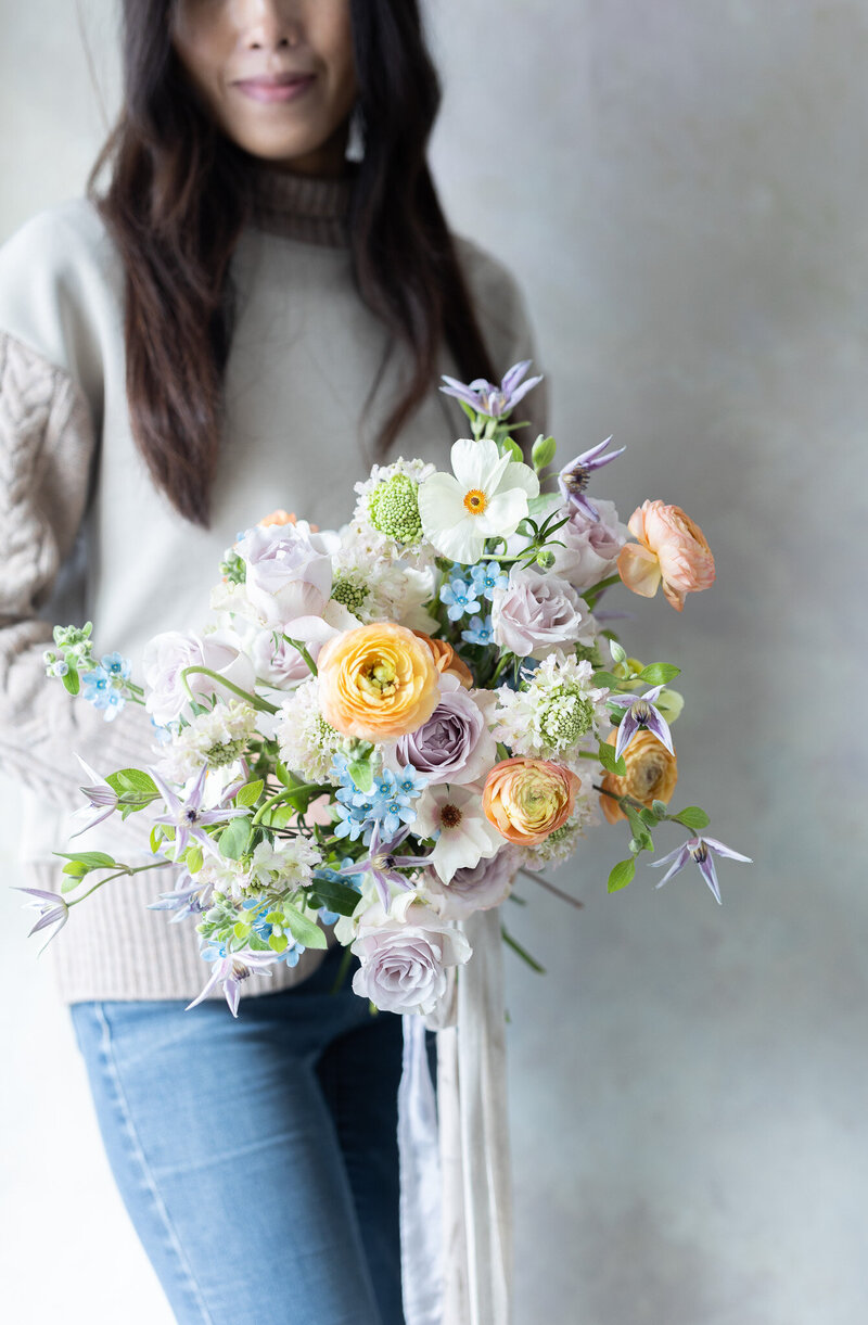 Lavender wedding bouquet with peach accent by Koko Flora