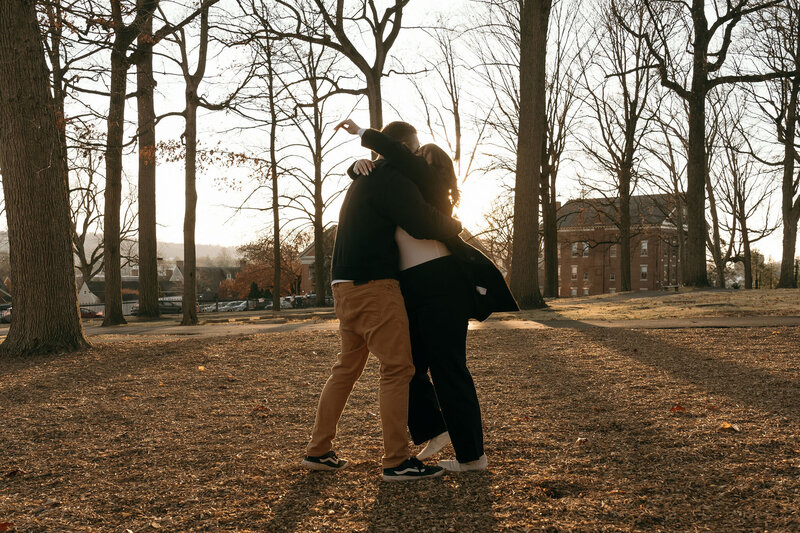 couple mid-embrace at sunset