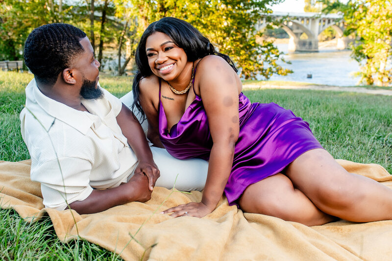 A stylish Black couple captured at the SC Statehouse, with the woman in the foreground and the focus on the groom. A dramatic and artistic moment showcasing elegance and style.