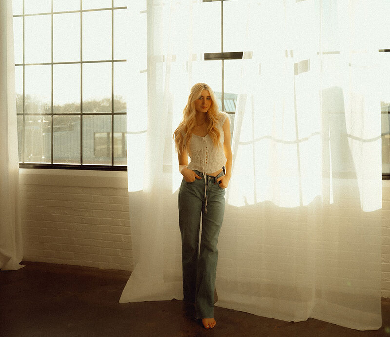 Young Woman in front of window at East End Studio for her Lifestyle Photos