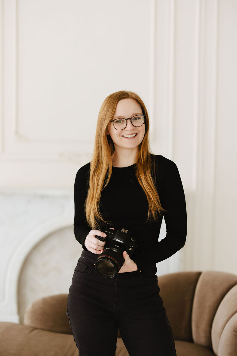 Female sitting in a studio rental space with her camera in Chicago.