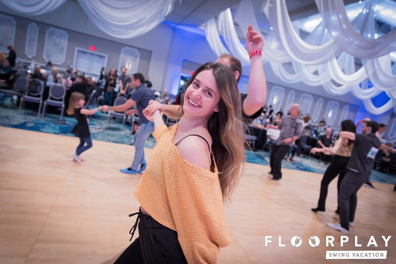 A dancer enjoying a West Coast Swing dance with her partner at Floorplay Swing Vacation New Years Event weekend event