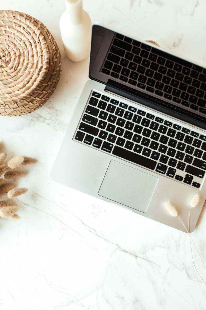 Laptop next to a woven basket