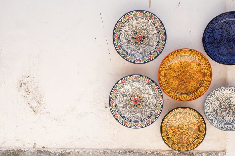 Brightly colored moroccan plates handing on a wall
