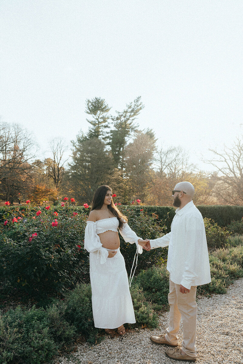 pregnant woman smiling at husband during maternity photoshoot captured by NYC maternity photographer Elsie Goodman 
