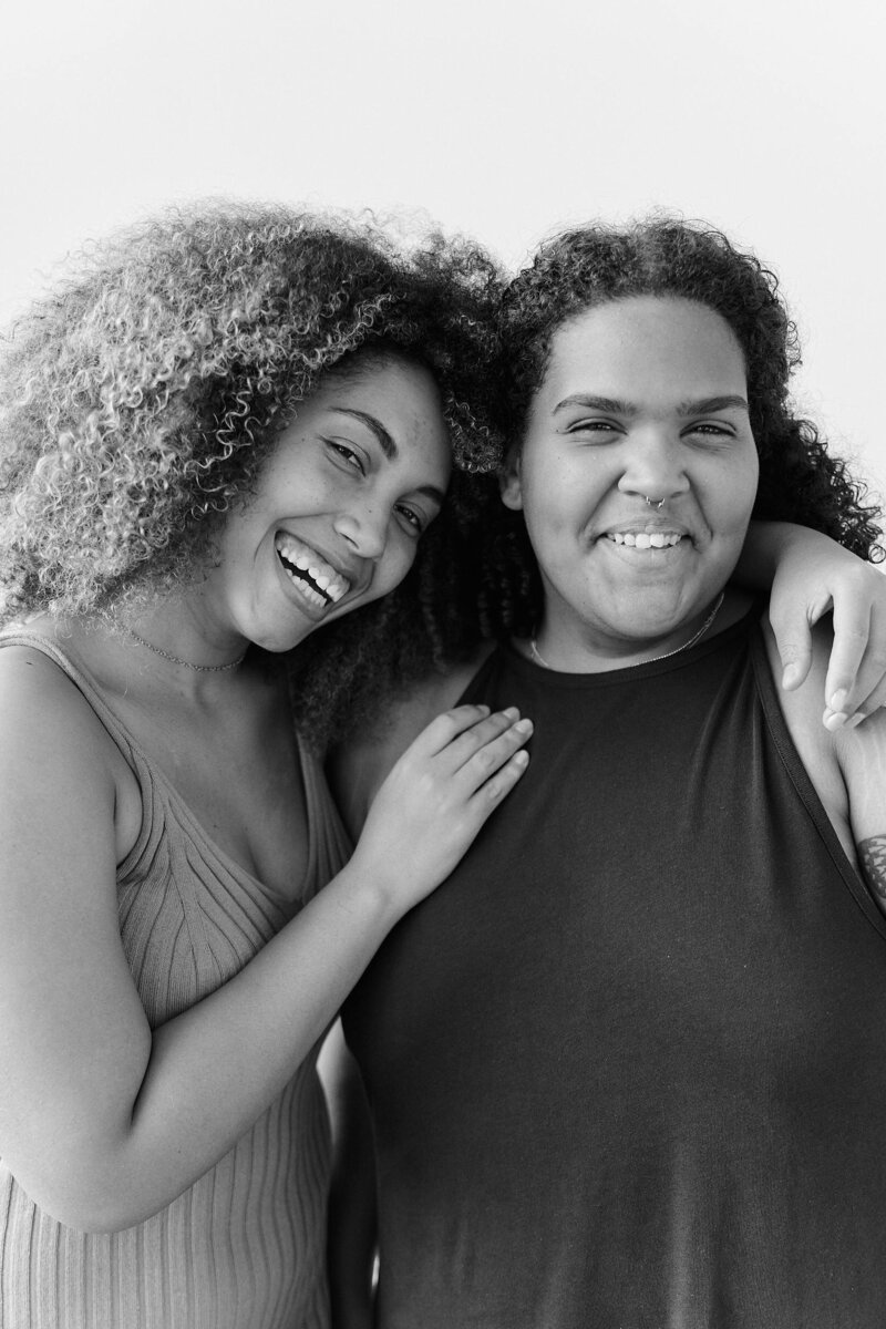 two women standing together smiling