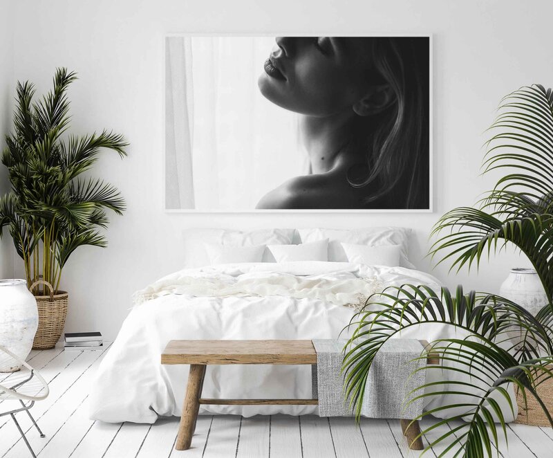 art print of woman mounted above the bed