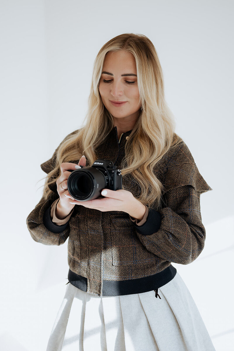 utah wedding photographer holding camera