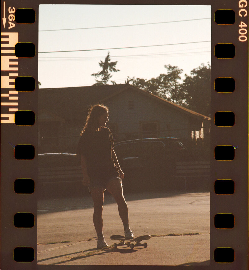 Girl standing on her skateboard in a Seattle park