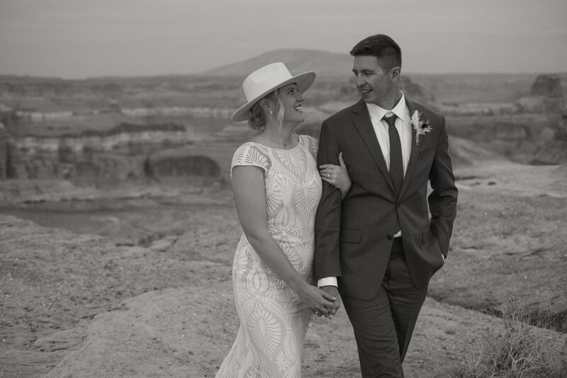 Bride and Groom holding hands walking at Alstrom Point Lake Powell