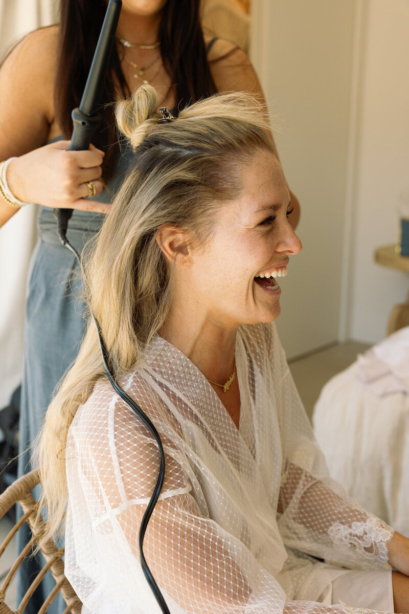 bride getting hair styled