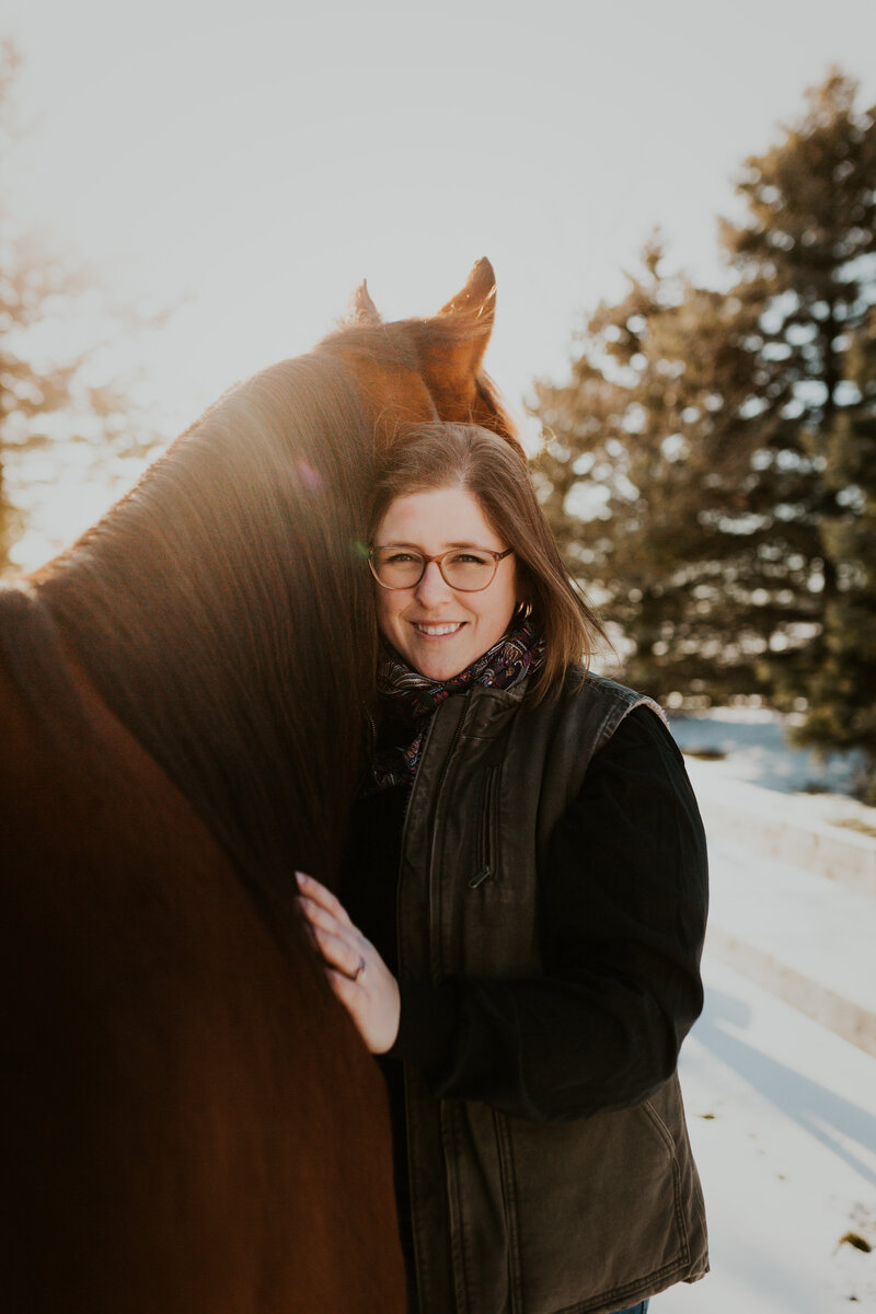 Horse and rider sharing a candid moment in Ontario, captured by an equine lifestyle photographer specializing in natural light photography.