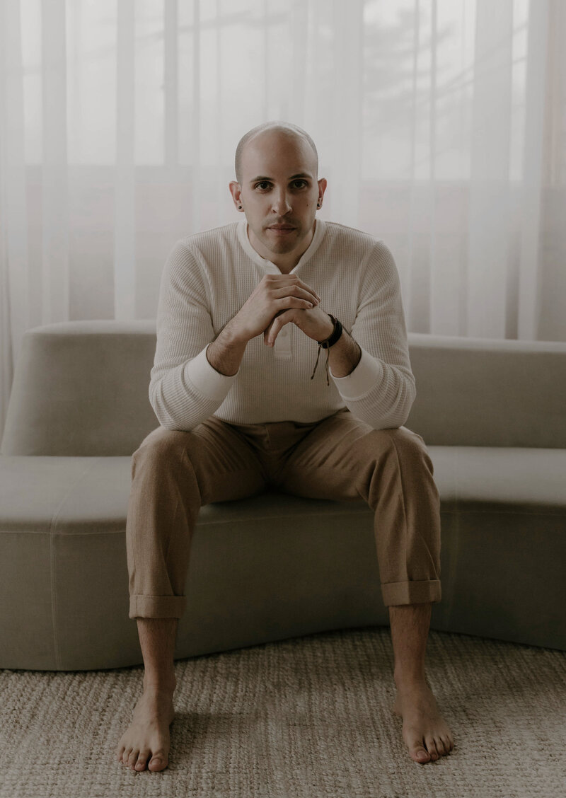 Our copywriter sitting on a sofa with his laptop.