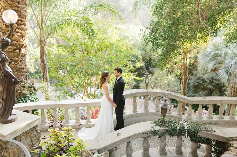 bride and groom stand on bridge at The Houdini Estate