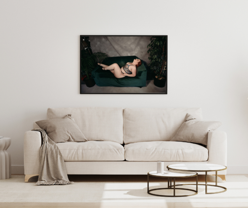 A black framed wall art piece  of woman laying on a coach with lingerie in Minneapolis Mn