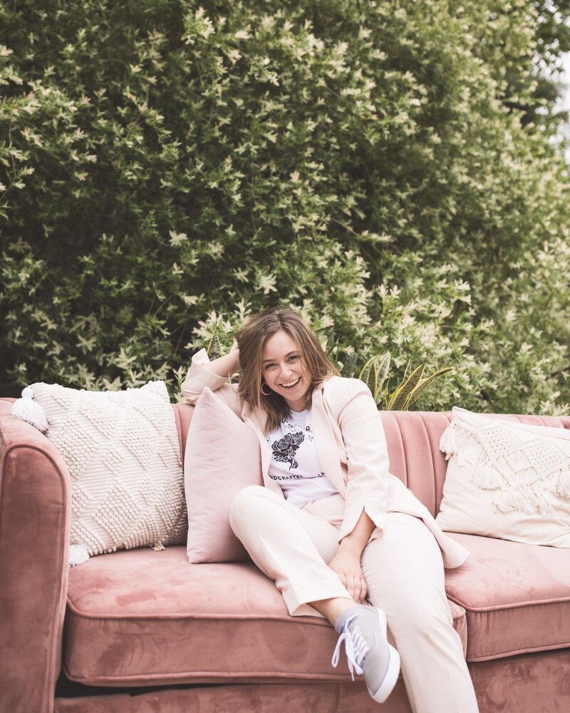 headshot of Rebecca Gatto sitting outside on a pink couch