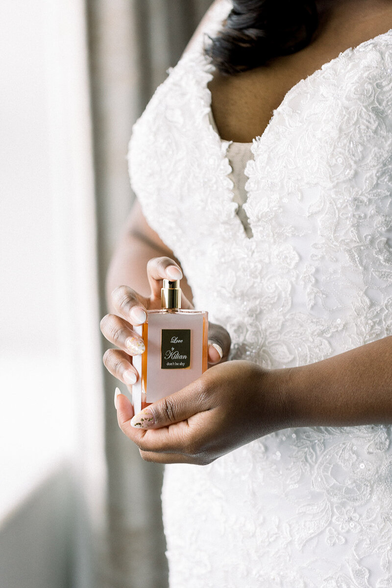 bride holding perfume