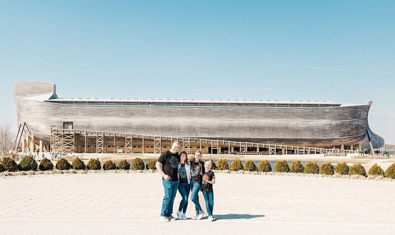 Family standing close outdoors at the Ark Encounter.