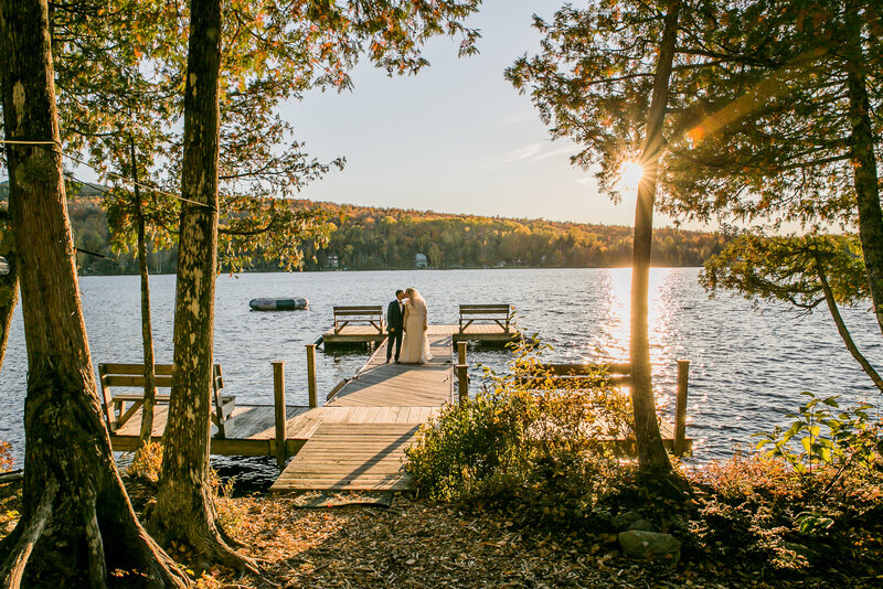 Bride and Groom standing on dock together | Rangeley, Maine Wedding Photography