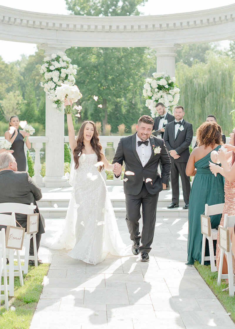 wedding couple walking away from ceremony after first kiss at their florida wedding.