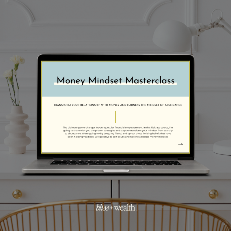 A macbook sits atop a white desk with a vase of flowers beside it displaying a Money Mindset Masterclass, a mini course focused on improving your financial mindset and creating abundance and prosperity.