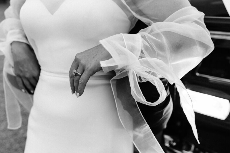 close up of brides hera couture sheer sleeves with bow on the cuff