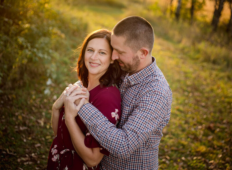 Man Wrapping Arms Around Woman