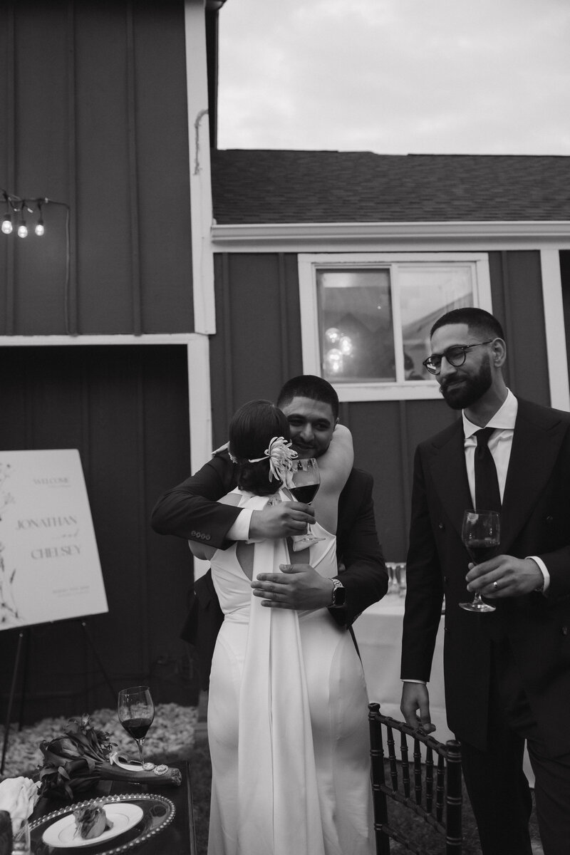 bride hugging a wedding guest at their intimate wedding reception