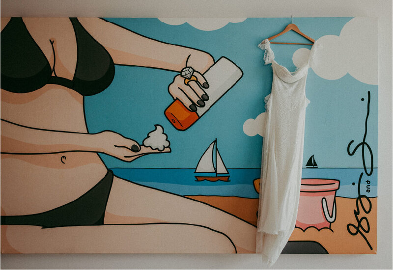wedding dress on hanger with mural