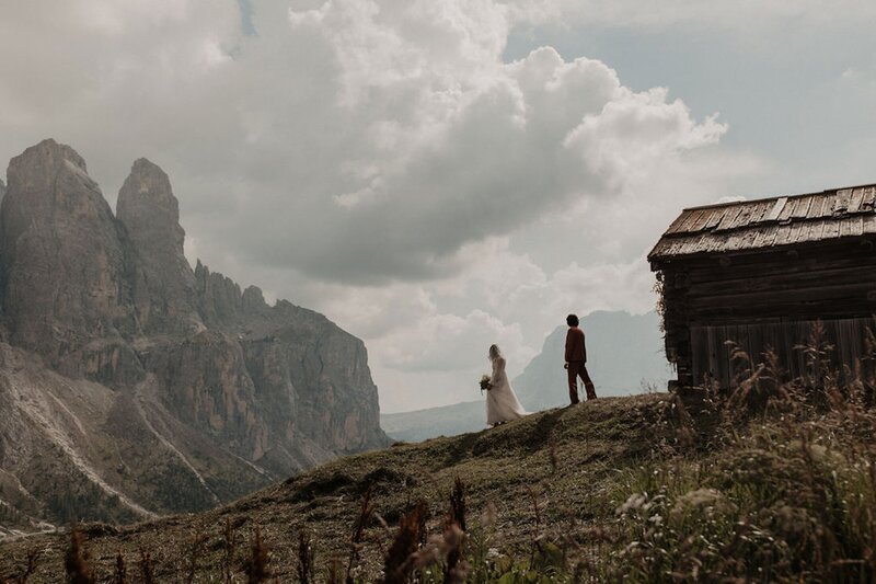 bride and groom walking down hill side