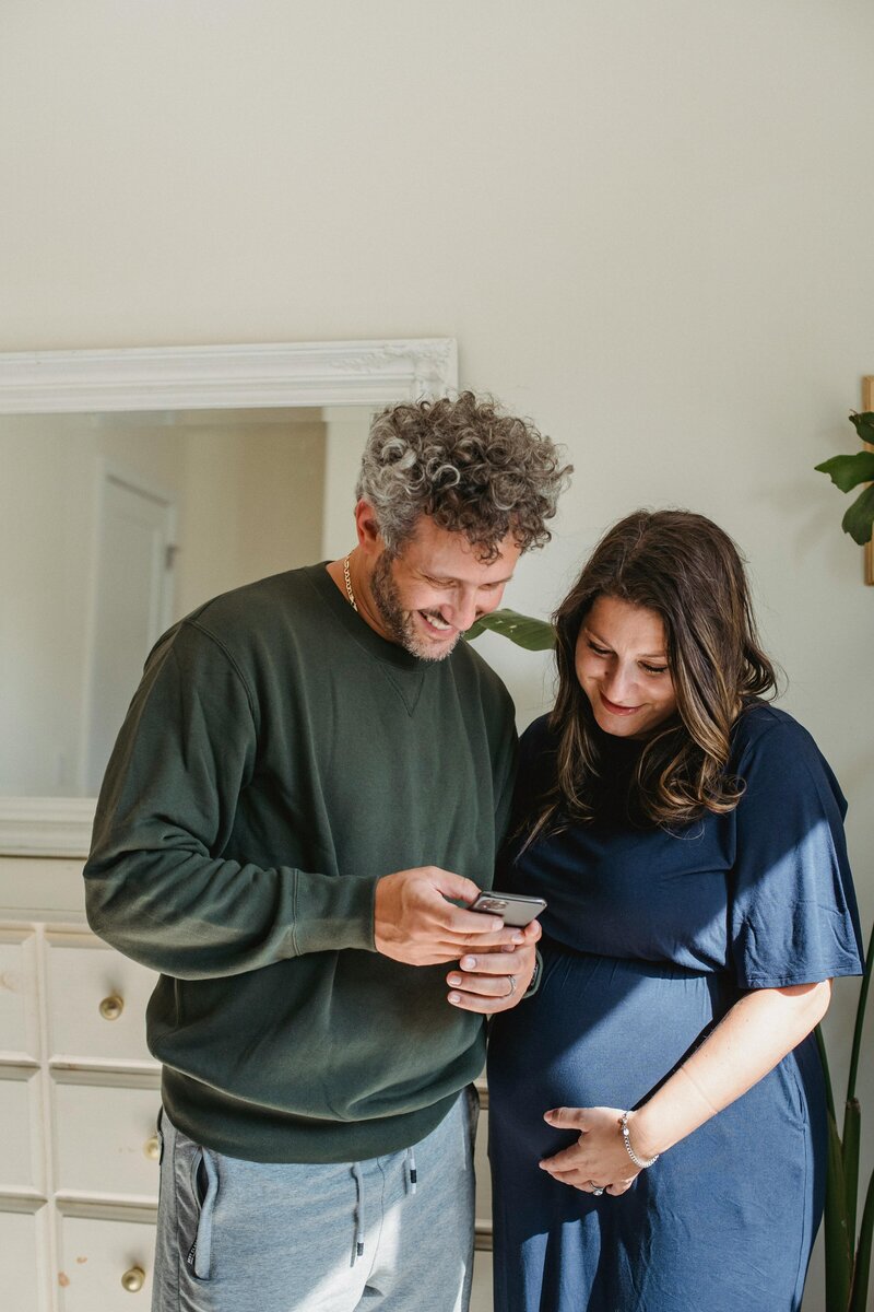 pregnant woman and man on phone scheduling an appointment