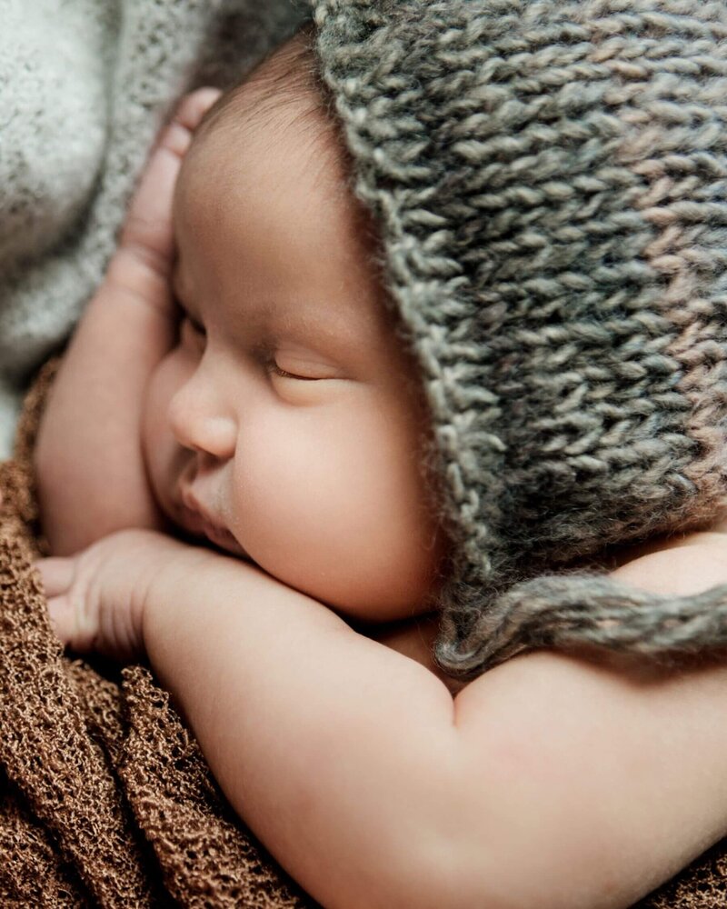 Newborn baby girl sleeping peacefully in the studio of Tracy Miller Photography