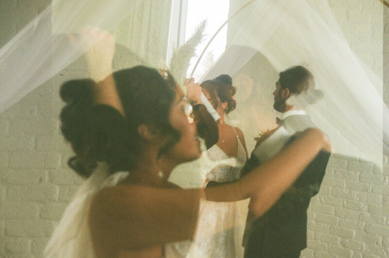 Candid moment of a bride wiping away tears during an intimate Ottawa elopement ceremony