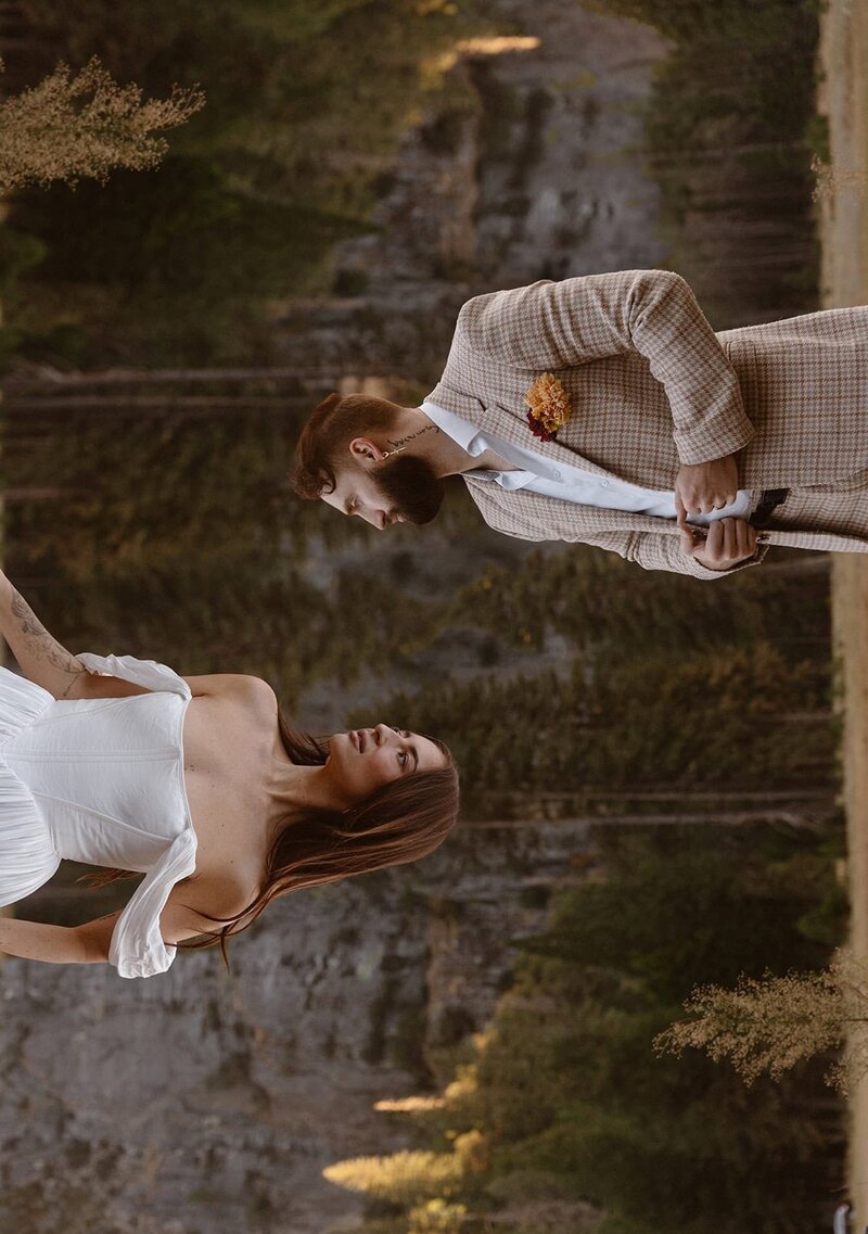 Double exposure image of bride and groom standing and facing each other surrounded by Yosemite granite and valley trees