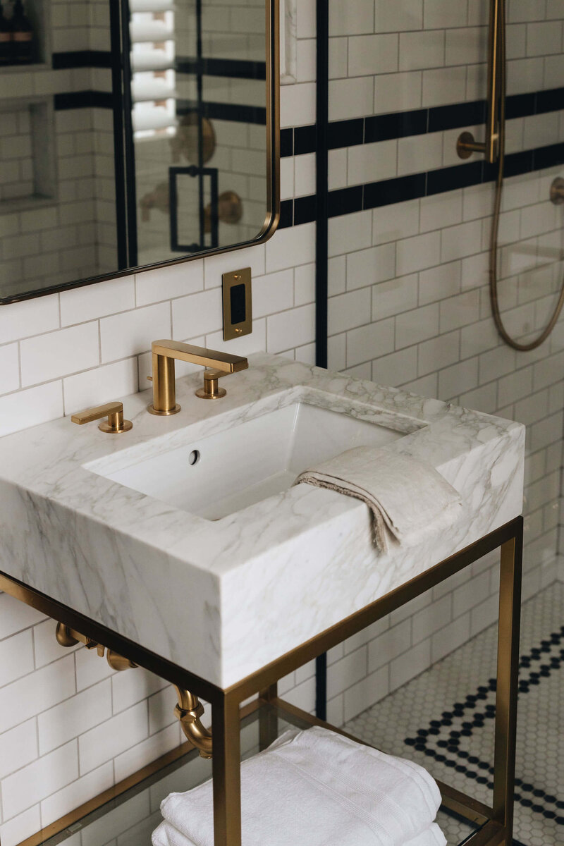 Kohler modern brushed brass hardware and sleek marble vanity