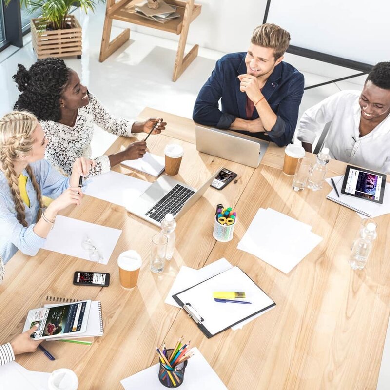 Publishing team collaborating on book marketing strategies and editorial services, discussing manuscript editing and promotion ideas for new authors.