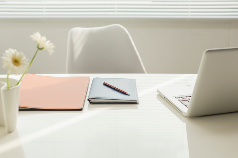 Tidy, elegant office space with laptop and chair