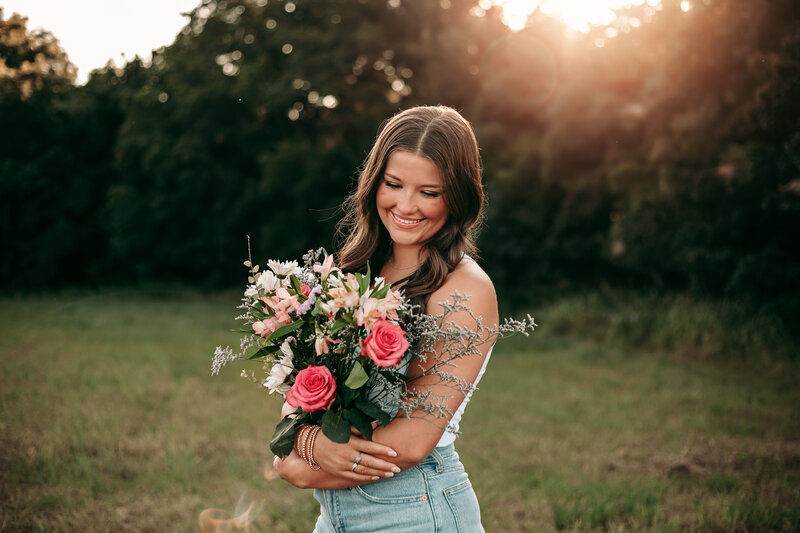 girl at sunset in field with flowers photo