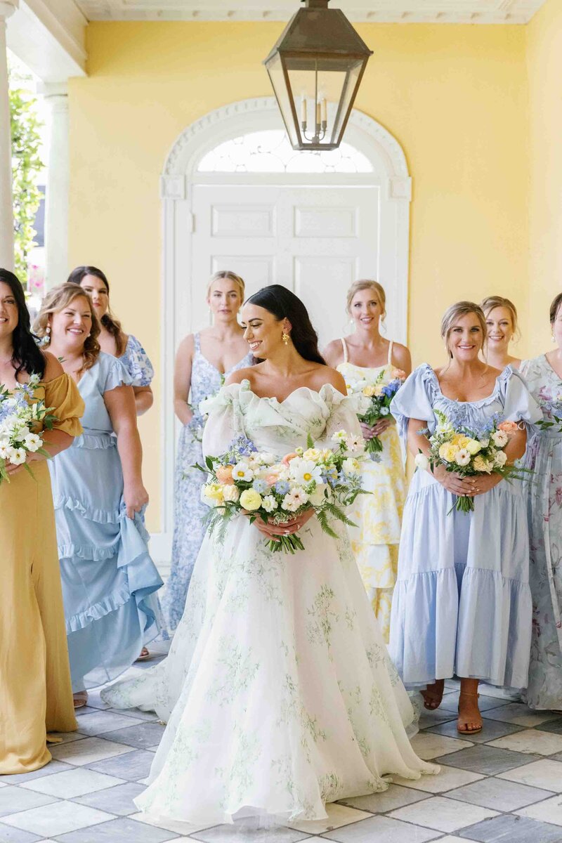 bride walking with bridesmaids at william aiken house